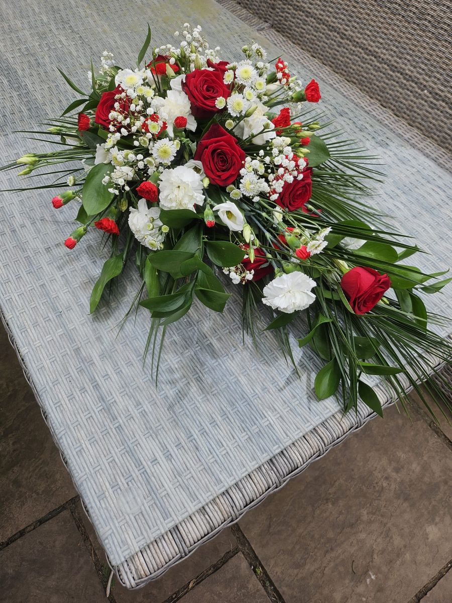 Red & white casket spray by Wright Stripes Floristry